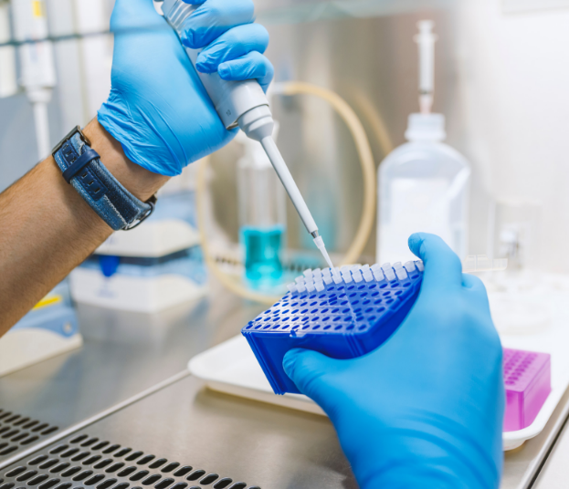 scientist using a pipette in a lab