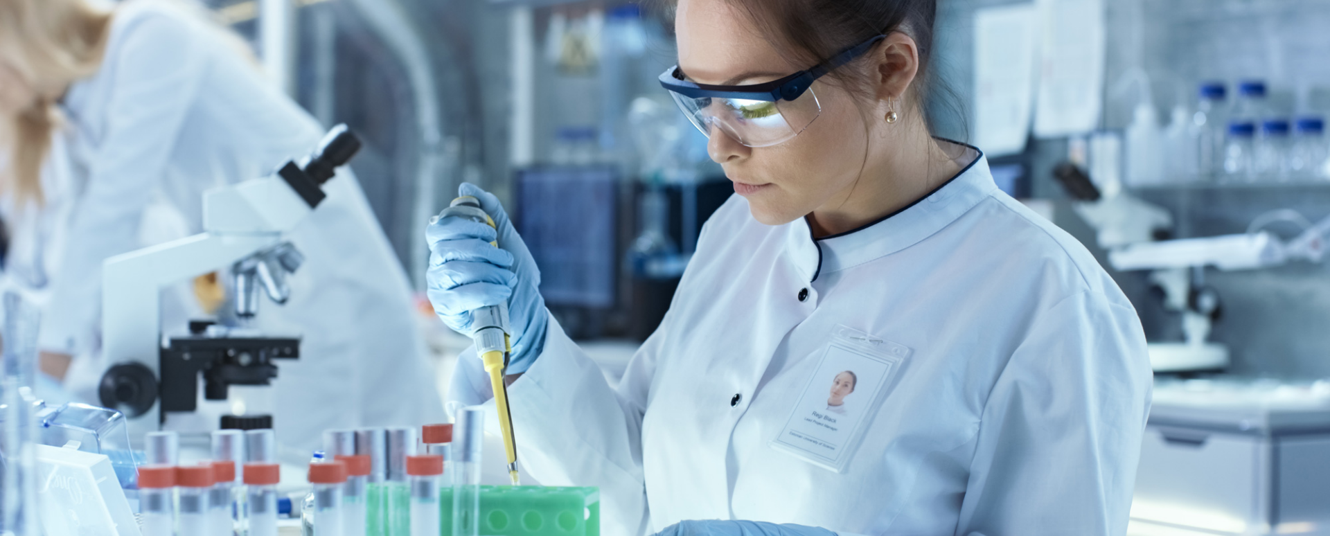 scientist using a pipette in a lab