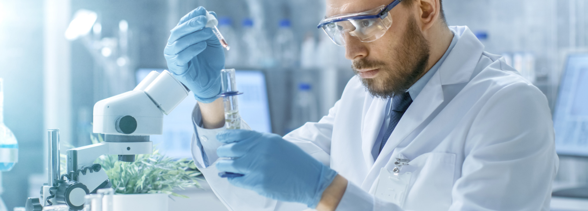 scientist testing a sample in a lab with a test tube